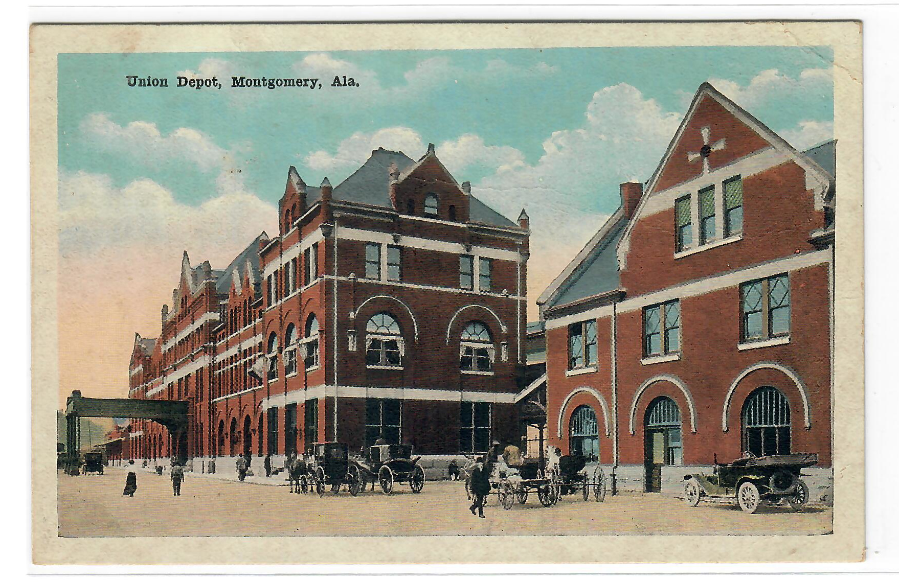 Color postcard of Union Depot, Montgomery, Alabama, with red brick building, horse-drawn carriages, and early cars.